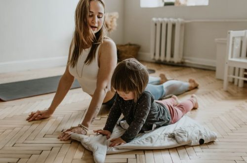 A mother and child practicing yoga together at home on a sunny day, fostering wellness and connection.