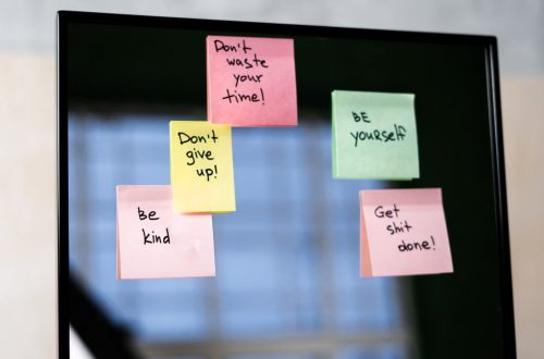 Colorful sticky notes on a mirror provide daily motivational messages and positivity reminders.